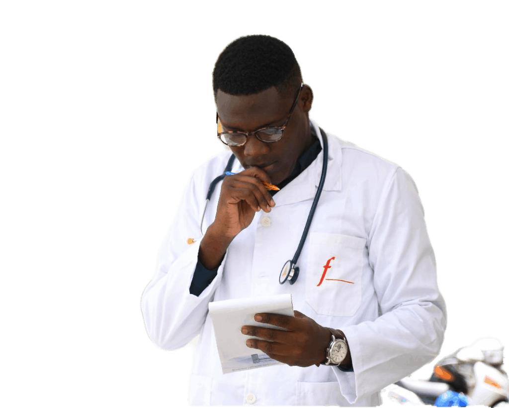 A man in a white lab coat is looking at a tablet.